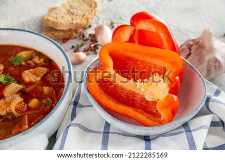 Ripe paprika and Hungarian goulash soup on the table. Traditional cuisine, national dish.