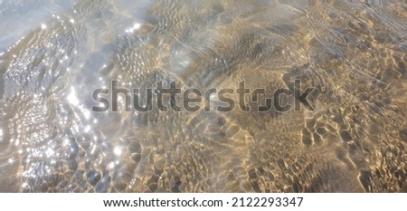 photo of sea water on sand