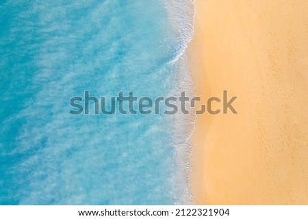 Aerial view of sandy beach and ocean nature with waves. Beach and waves from top view. Turquoise water background. Summer seascape from air. Aerial drone landscape. Travel vacation concept and idea