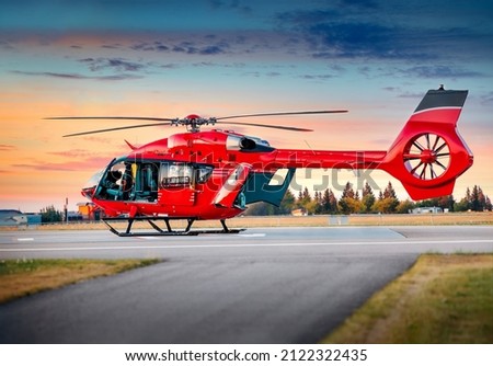 Red color helicopter. Great photo on the theme of air medical service, air transportation,  air ambulance,  fast city transportation or helicopter tours.  Royalty-Free Stock Photo #2122322435