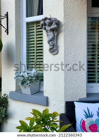 Stylish English garden decoration with flower pot and sculpture