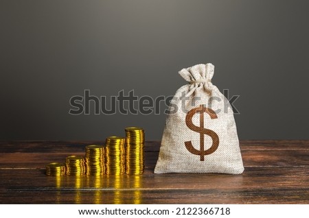 Dollar money bag and increasing stacks of coins. Savings and accumulation. Economic growth, GDP. Rise in profits, budget fees. Investments. Raise incomes, increase salaries. Financial success. Bonus Royalty-Free Stock Photo #2122366718
