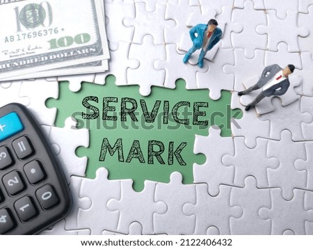 Top view calculator,banknotes and miniature people with text SERVICE MARK on a white puzzle background