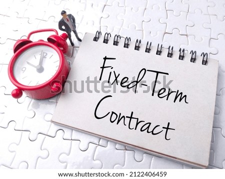 Top view clock and miniature people with text Fixed-Term Contract on a white puzzle background Royalty-Free Stock Photo #2122406459