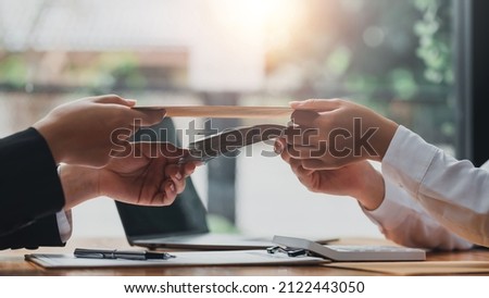 Business people giving bribe and collaborating with corruption. Bribery and corruption concept. Royalty-Free Stock Photo #2122443050