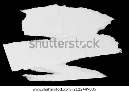 White paper ripped pieces isolated on black background. Dirty wrinkled glued paper poster texture Royalty-Free Stock Photo #2122449035
