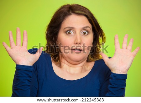 Closeup portrait headshot business woman, employee, funny looking female, shocked, scared trying protect herself, unpleasant situation, isolated green background. Negative emotions, facial expression