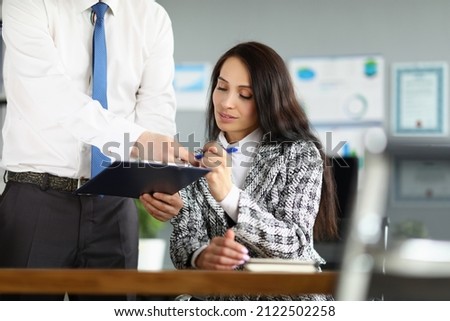 Man giving contract paper to businesswoman to sign, worker give agreement paper to boss
