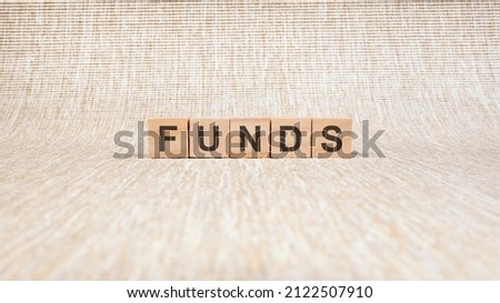 funds written in wooden cubes. conceptual word collected of of wooden elements with the letters. stock image, brown background