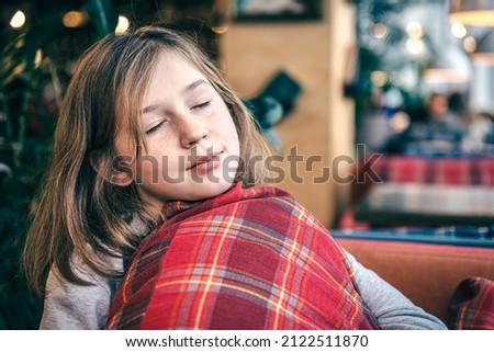 Portrait of a little girl with a pillow in a beautiful interior.