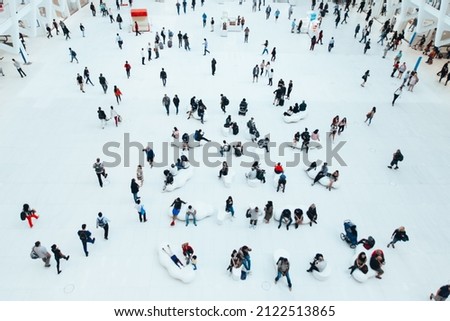 Blurred concept with a mass of people doing things. view from above