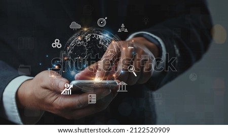 Businessman using mobile smartphone shows the future world of the metaverse with internet technology icons, Digital Marketing, Financial and banking, Metaverse, Digital link tech, Big data concept.