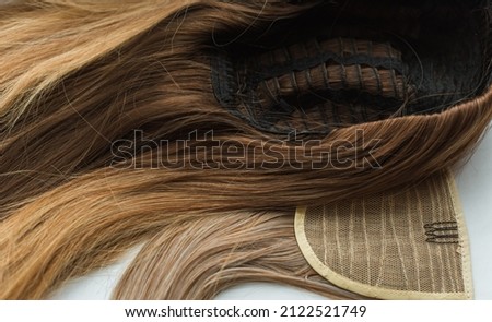 Wigs, natural and synthetic hair. Women's beauty concept. Close up photo of wig, hair for ladies Royalty-Free Stock Photo #2122521749