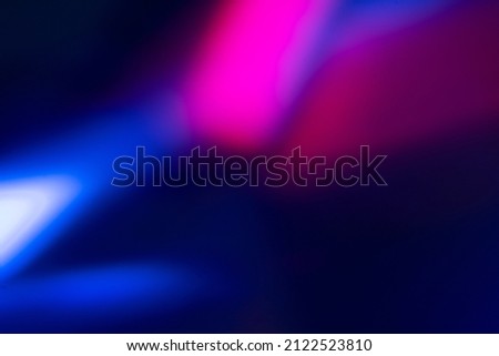 Blur color glow. Fluorescent background. Night party light. Defocused neon magenta pink blue illumination rays on dark abstract overlay.