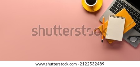 A top view of office utilities flat lays such as note books, laptop and a cup of coffee on an empty pink space on a background, for business and technology concept. Royalty-Free Stock Photo #2122532489