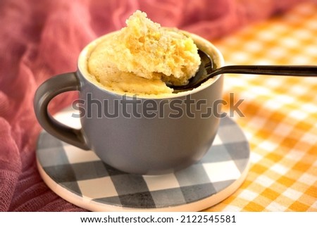 cake in a mug. dessert. Vanilla dessert cooked in the microwave. cake mug. Easy, fast to cook.vanilla biscuit in a spoon . Close-up of banana flavored mugcake. homemade cupcake recipe. Royalty-Free Stock Photo #2122545581