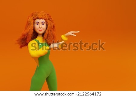 red-haired girl on an orange background points to