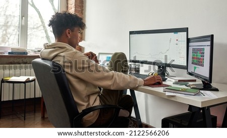 Worried stressed african american trader vaping and watching data index chart stock market. Thinking of problem solution. Working distantly, self isolation concept.