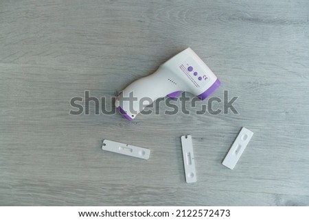 Covid-19 antigen test with negative results and digital thermometer