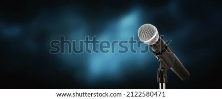 Microphone with stage light background for performance concept of speech comment and public speaking