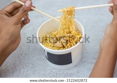 Fried noodles with pentol in a white cup, fried instant noodles in a white cup mockup.