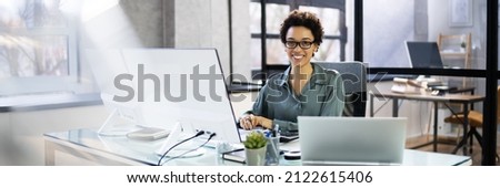 African Accountant Woman In Office Using Computer