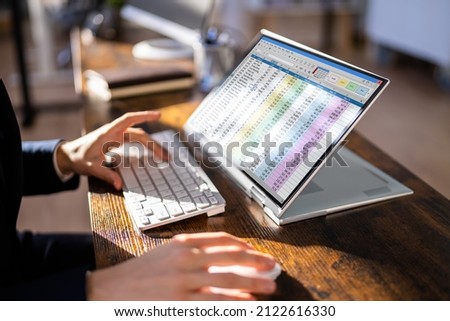 Electronic Spreadsheet Analyst Or Auditor Using Software On Hybrid Laptop Royalty-Free Stock Photo #2122616330