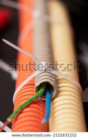 wire cutters with electric cable, plastic ties, and a colored outer shell for electrical wiring Royalty-Free Stock Photo #2122631252