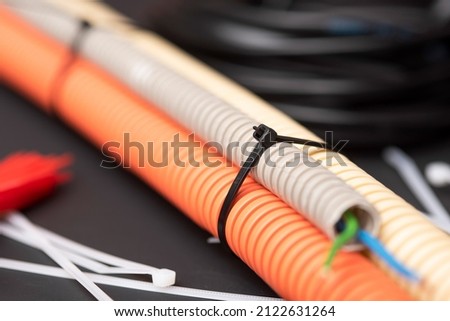 wire cutters with electric cable, plastic ties, and a colored outer shell for electrical wiring Royalty-Free Stock Photo #2122631264