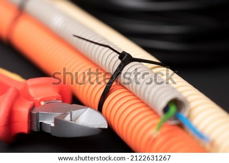 wire cutters with electric cable, plastic ties, and a colored outer shell for electrical wiring Royalty-Free Stock Photo #2122631267