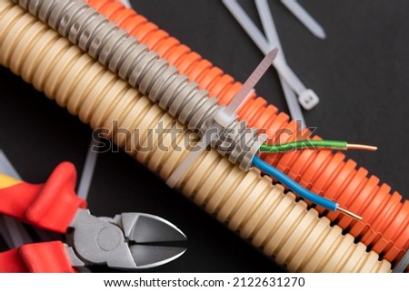 wire cutters with electric cable, plastic ties, and a colored outer shell for electrical wiring Royalty-Free Stock Photo #2122631270