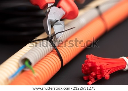 wire cutters with electric cable, plastic ties, and a colored outer shell for electrical wiring Royalty-Free Stock Photo #2122631273