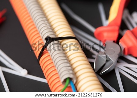 wire cutters with electric cable, plastic ties, and a colored outer shell for electrical wiring Royalty-Free Stock Photo #2122631276