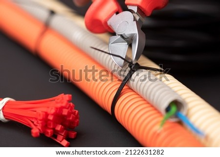 wire cutters with electric cable, plastic ties, and a colored outer shell for electrical wiring Royalty-Free Stock Photo #2122631282