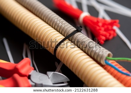 wire cutters with electric cable, plastic ties, and a colored outer shell for electrical wiring Royalty-Free Stock Photo #2122631288