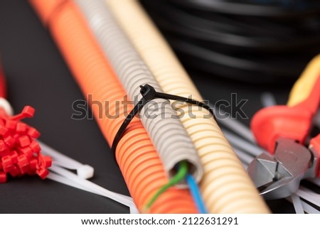 wire cutters with electric cable, plastic ties, and a colored outer shell for electrical wiring Royalty-Free Stock Photo #2122631291