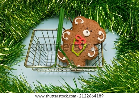 a bear-shaped gingerbread in a miniature grocery basket. High quality photo