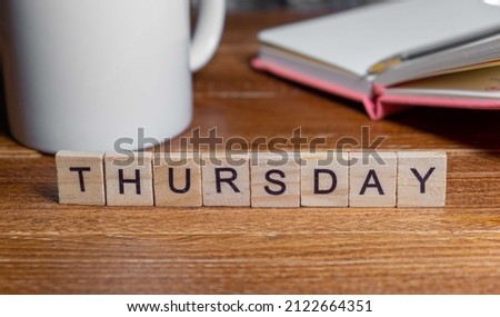 The word THURSDAY spelt out with wooden letter tiles