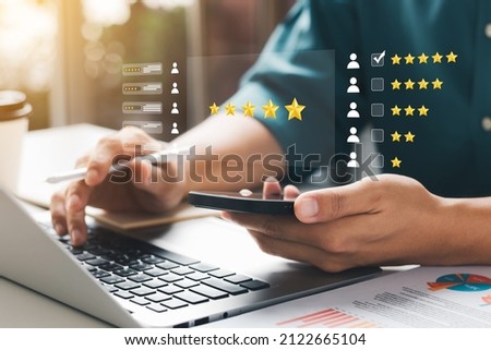 User give rating to service experience on online application, Customer review satisfaction feedback survey concept, Customer can evaluate quality of service leading to reputation ranking of business. Royalty-Free Stock Photo #2122665104