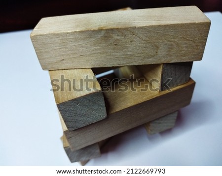 Wooden rectangular figures for playing django on a white background.
