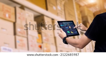 Smart Inventory management system concept.Manager using digital tablet,showing warehouse software management dashboard on blurred warehouse as background Royalty-Free Stock Photo #2122685987