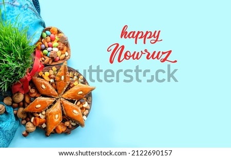 Happy Nowruz greeting card. arabic dessert baklava, sweets, nuts, dry fruits, green wheat grass on blue background. Traditional celebration of spring equinox in March, Nowruz Holiday. top view