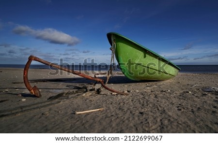 A working fishing boat on the beach at Dungeness on the Kent coast Royalty-Free Stock Photo #2122699067