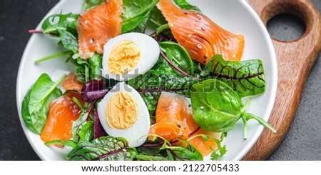 salad salted salmon, eggs, green leaves lettuce fresh portion healthy meal food diet snack on the table copy space food background rustic keto or paleo diet veggie vegetarian pescatarian diet Royalty-Free Stock Photo #2122705433
