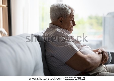 Sad pessimistic old senior man feeling depressed, lonely, apathy, boredom, getting dementia, Alzheimer disease, memory loss, going through grief, thinking over mental health problems Royalty-Free Stock Photo #2122713812