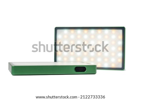 Portable rechargeable RGB LED panel for illumination during video shooting. Two lamps isolated on a white background