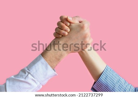 hands of man and woman in struggle for gender equality, female independence, male masculine power, confrontation. feminism concept. international womens day 8 march. arm wrestling