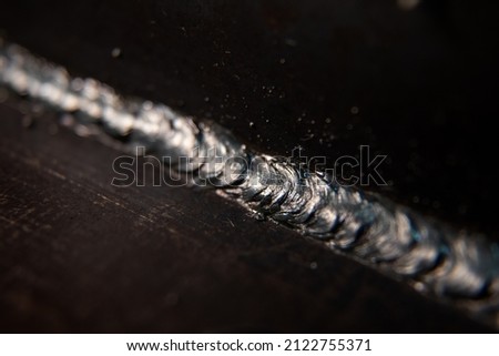 a closeup picture of a weld connecting two steel plates