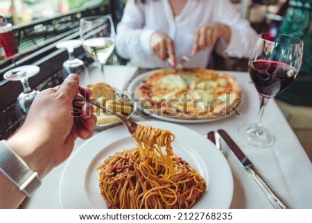 couple eating in restaurant pasta and pizza drinking wine first person point of view no face