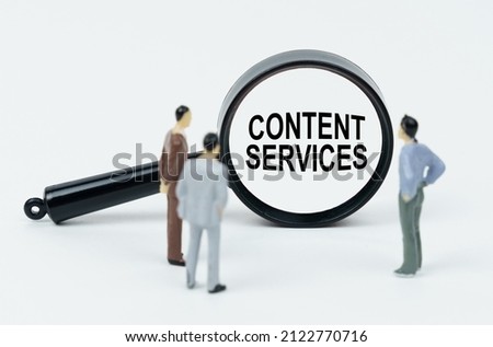 Economy and business concept. On a white background there are figures of businessmen and a magnifying glass, inside of which there is an inscription - Content Services